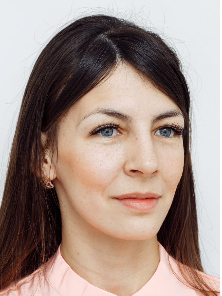 Woman with long brown hair, pink shirt.