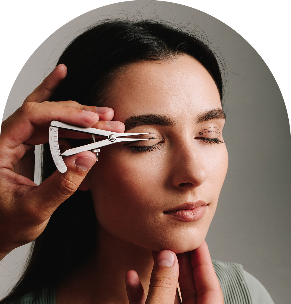 Eyebrow measurement with precision caliper tool.